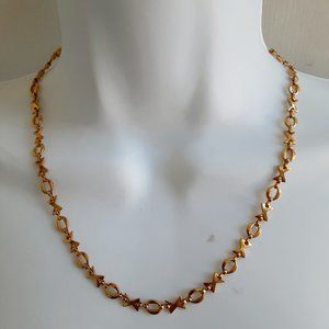X O gold tone necklace